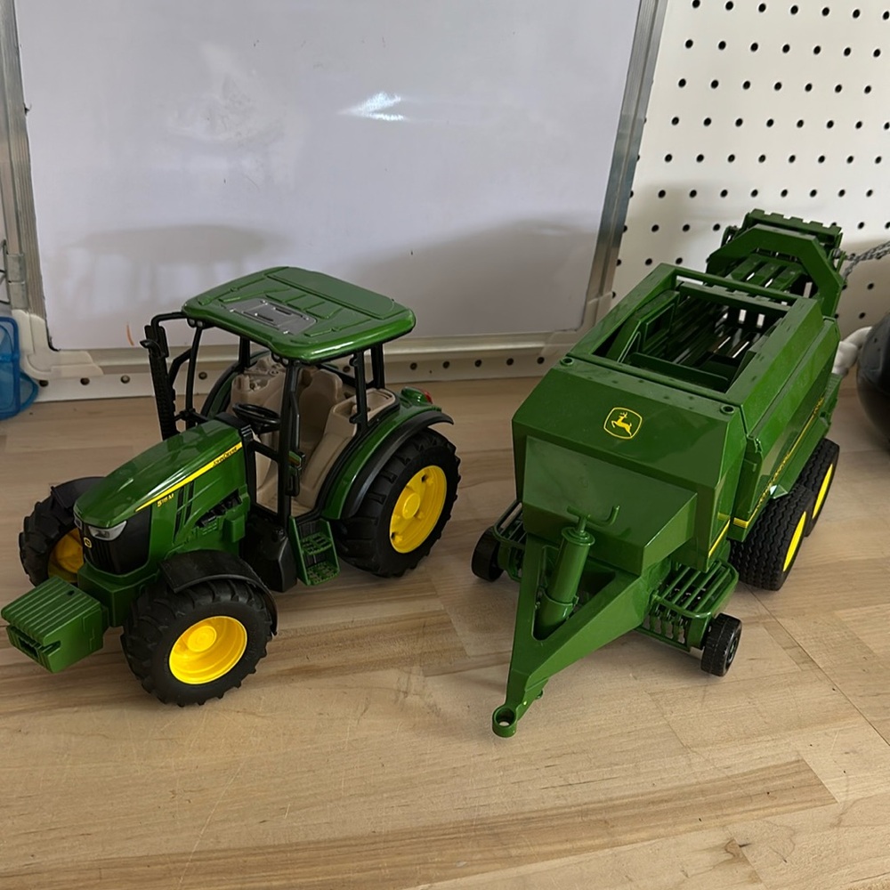 Bruder tractor with hay baler attachment and hay